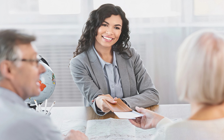 A travel agent in Tamil Nadu explaining tour booking terms and conditions to clients- eswar tours